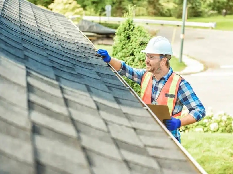 Professional roofing inspector examining a residential roof in Texas